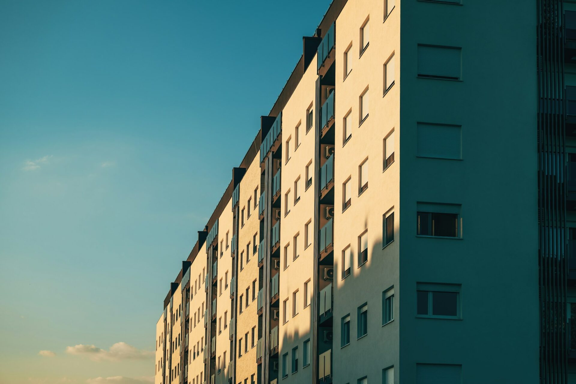 Residential condominium apartment building with windows facing west side lit by the sunset sun