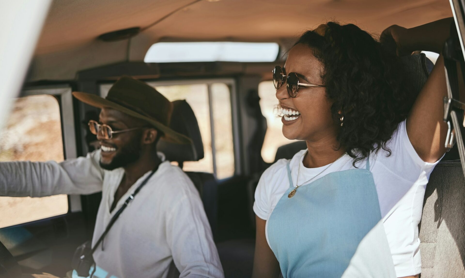 Road trip, driving and black couple drive to travel on a summer vacation with a smile. Happy girlfr